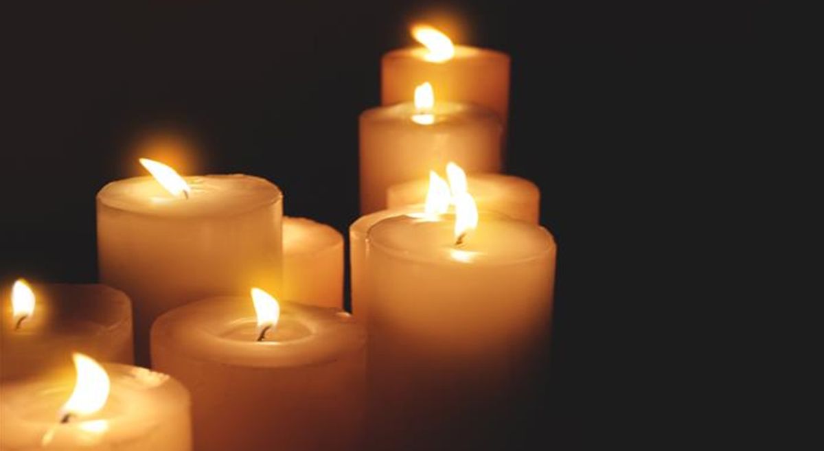 Picture of candles lit in a dark room. 